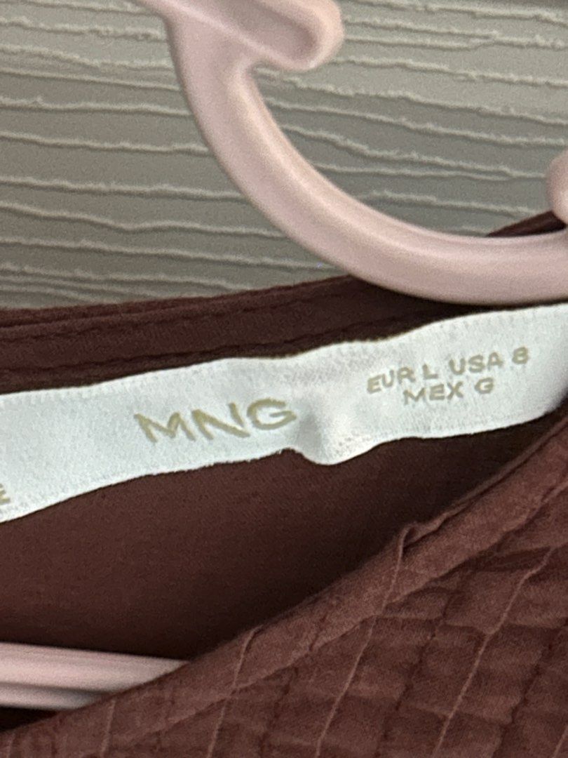 MANGO Brown Long Sleeve Blouse Size L (Category: Longsleeves) located in Makati City. Submitted by sophcrates (Listing ID 1467984445, Image 3). Description: - Brand: MANGO - Size: EUR L / USA 8 / MEX G - Color: Brown - Design: Round neckline with back button closure - Details: Beautiful cutout embroidery on the chest and front RFS decluttering PM for more info last price indicated .
