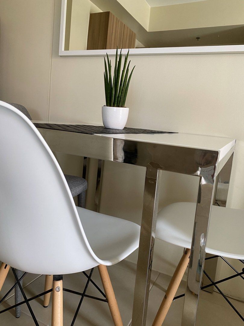 Modern 4-Seater Dining Table and Chairs Set (Category: Tables & Sets) located in Taguig. Submitted by janhyds (Listing ID 1467953931, Image 1). Description: - Space-saving rectangular dining table with a sleek white top and chrome legs - Includes 4 chairs: 2 white molded plastic chairs with wooden dowel legs and 2 grey upholstered fabric chairs - Modern, neutral design that fits apartment living and contemporary interiors - Sturdy and durable con