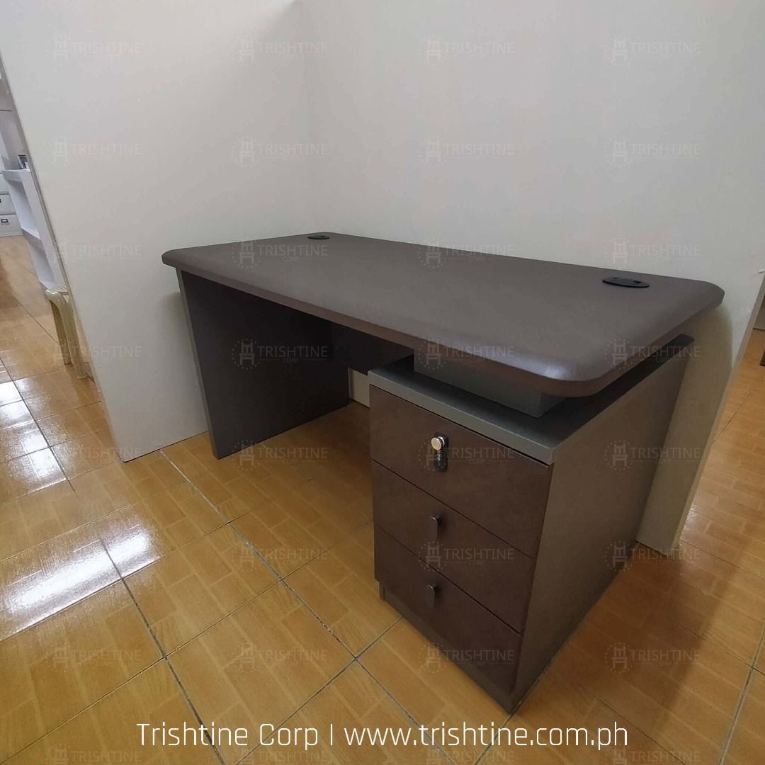 Modern Executive Office Desk with 3 Drawers (Category: Office Furniture & Fixtures) located in Caloocan City. Submitted by jim.trishtineofficefurnitures (Listing ID 1467887588, Image 3). Description: - Sturdy executive office desk in a sleek dark wood finish - Built-in 3-drawer cabinet with key lock for secure storage - Two black cable grommets on the desktop for neat wire management - Clean lines and a spacious surface area for maximum productiv