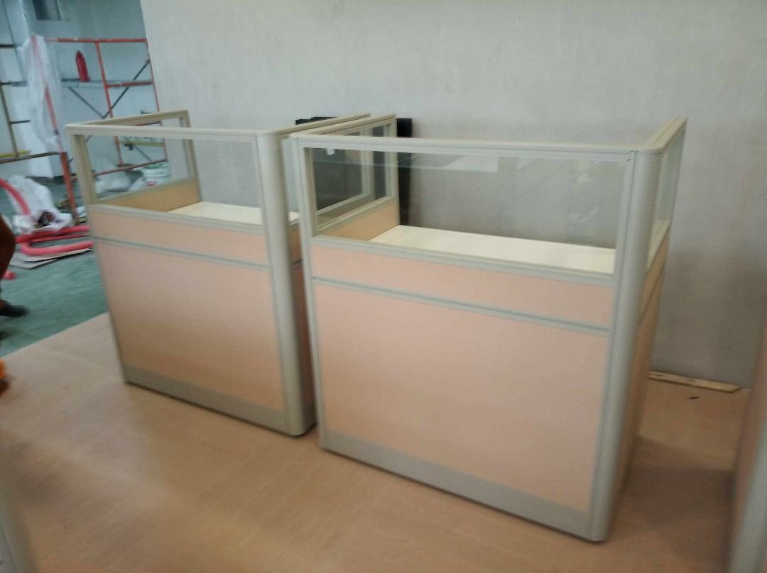 Modular Office Cubicle Desk with Glass Partition (Category: Office Furniture & Fixtures) located in Caloocan City. Submitted by jim.trishtineofficefurnitures (Listing ID 1467921875, Image 3). Description: - Office cubicle desk set featuring stylish light pink fabric panels and frosted glass top sections - Spacious white work surface equipped with a built-in cable management grommet - Durable and sturdy metal frame construction for long-lasting us