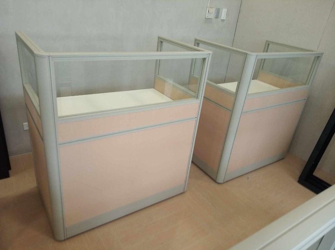 Modular Office Cubicle Desk with Glass Partition (Category: Office Furniture & Fixtures) located in Caloocan City. Submitted by jim.trishtineofficefurnitures (Listing ID 1467921875, Image 1). Description: - Office cubicle desk set featuring stylish light pink fabric panels and frosted glass top sections - Spacious white work surface equipped with a built-in cable management grommet - Durable and sturdy metal frame construction for long-lasting us
