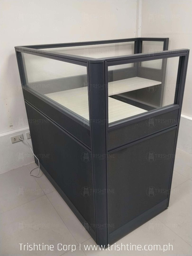 Modular Office Cubicle Workstation Desk Partition (Category: Office Furniture & Fixtures) located in Caloocan City. Submitted by jim.trishtineofficefurnitures (Listing ID 1467889103, Image 1). Description: - Dark grey panels with stylish white woodgrain desktop - Glass top dividers for a semi-private, modern workstation setup - Built-in wire management hole to keep cables neat and organized - Sturdy frame construction designed for durability - Mo