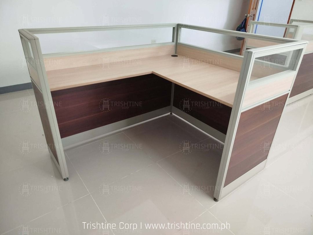 Modular Office Cubicle Workstation L-Shape Desk Partition (Category: Office Furniture & Fixtures) located in Caloocan City. Submitted by jim.trishtineofficefurnitures (Listing ID 1467896041, Image 3). Description: - Modular L-shaped office workstation set - Wooden desktops with dark brown lower panels - Modern glass top dividers - Durable aluminium frames throughout - Built-in cable management grommets - Perfect for team seating and open office l