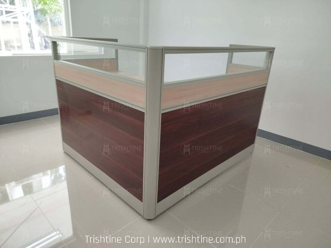 Modular Office Cubicle Workstation L-Shape Desk Partition (Category: Office Furniture & Fixtures) located in Caloocan City. Submitted by jim.trishtineofficefurnitures (Listing ID 1467896041, Image 2). Description: - Modular L-shaped office workstation set - Wooden desktops with dark brown lower panels - Modern glass top dividers - Durable aluminium frames throughout - Built-in cable management grommets - Perfect for team seating and open office l