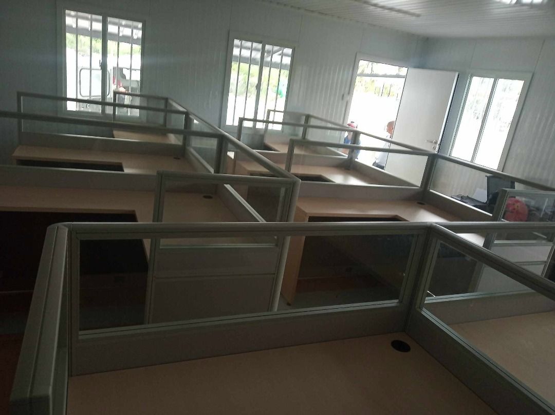 Modular Office Cubicle Workstations With Glass Partitions (Category: Office Furniture & Fixtures) located in Caloocan City. Submitted by jim.trishtineofficefurnitures (Listing ID 1467921608, Image 3). Description: - Modular office partitions and desks set up in rows - Light wood tone desktops with built-in cable grommets - Sturdy aluminium framing with frosted lower panels and upper glass dividers - Ample under-desk space and storage options - Id