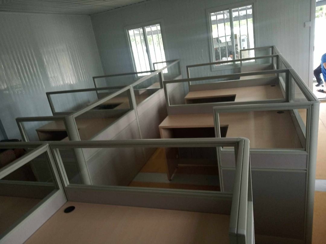 Modular Office Cubicle Workstations With Glass Partitions (Category: Office Furniture & Fixtures) located in Caloocan City. Submitted by jim.trishtineofficefurnitures (Listing ID 1467921608, Image 2). Description: - Modular office partitions and desks set up in rows - Light wood tone desktops with built-in cable grommets - Sturdy aluminium framing with frosted lower panels and upper glass dividers - Ample under-desk space and storage options - Id