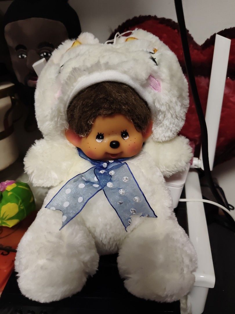 Monchhichi Bunny Plush Doll White with Blue Bow (Category: Plushies & Soft Toys) located in Pasay City. Submitted by ynamariie (Listing ID 1467909405, Image 1). Description: - Adorable 7-inch Monchhichi plush doll - Wears a sweet white bunny hood with a blue polka dot ribbon bow - Features signature brown hair, freckled face, and soft white fur - Flaw note: Minor glue stain on the back of the hood (visible in photos)(missing both hands) - Perfect