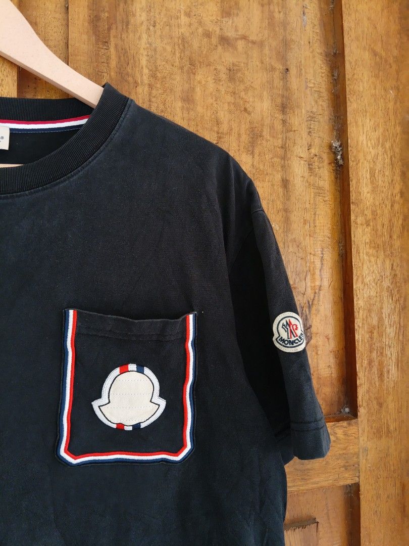 Moncler Pocket T-Shirt Black (Category: Tshirts & Polo Shirts ) located in Cateel. Submitted by melvin_122 (Listing ID 1467880434, Image 3). Description: - Brand: Moncler - Color: Black - Material: Soft cotton jersey for everyday comfort - Design: Short sleeves with signature Tricolor trim on the chest pocket and inner collar - Details: Moncler logo patch on left sleeve and embroidered emblem on the pocket - Authenticity: Includes internal label 