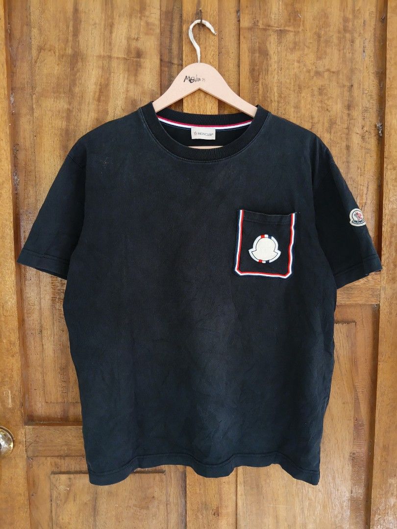 Moncler Pocket T-Shirt Black (Category: Tshirts & Polo Shirts ) located in Cateel. Submitted by melvin_122 (Listing ID 1467880434, Image 1). Description: - Brand: Moncler - Color: Black - Material: Soft cotton jersey for everyday comfort - Design: Short sleeves with signature Tricolor trim on the chest pocket and inner collar - Details: Moncler logo patch on left sleeve and embroidered emblem on the pocket - Authenticity: Includes internal label 