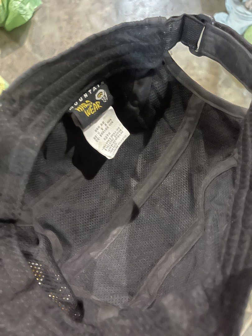 Mountain Hardwear Black Cap (Category: Caps & Hats) located in Valencia. Submitted by thriftyfinds01 (Listing ID 1468016371, Image 3). Description: - Brand: Mountain Hardwear - Color: Classic black with yellow embroidered logo on front and back - Material: Lightweight nylon with comfortable inner mesh lining - Closure: Adjustable strapback with secure plastic buckle - Condition: Great piece, complete with interior brand tags - Ideal For: Outdoor 