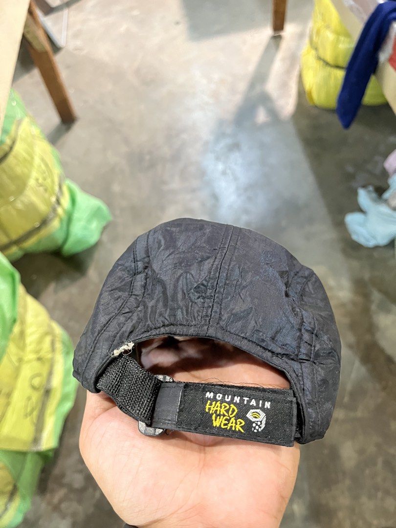 Mountain Hardwear Black Cap (Category: Caps & Hats) located in Valencia. Submitted by thriftyfinds01 (Listing ID 1468016371, Image 2). Description: - Brand: Mountain Hardwear - Color: Classic black with yellow embroidered logo on front and back - Material: Lightweight nylon with comfortable inner mesh lining - Closure: Adjustable strapback with secure plastic buckle - Condition: Great piece, complete with interior brand tags - Ideal For: Outdoor 