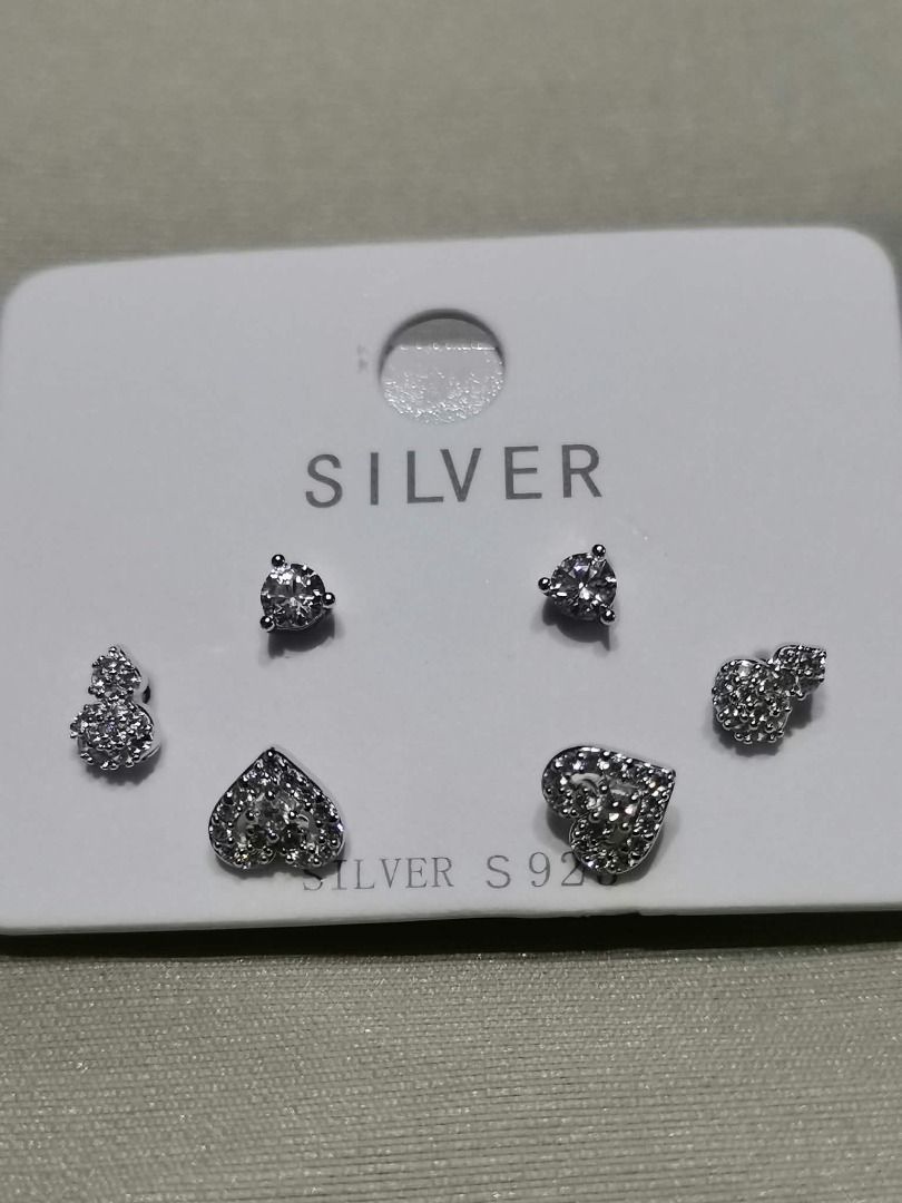 MPCZE14 MULTI-PAIR CUBIC ZIRCONIA Stud Sterling SILVER Earrings Set (Category: Earrings) located in Cavite. Submitted by falconsclawset (Listing ID 1467917527, Image 1). Description: - Set of 3 pairs of stud earrings featuring solitaire, heart, and gourd designs - Crafted with shimmering pave-set cubic zirconia details - Silver S925 stamped on the original display card - 100% brand new and unworn condition - Perfect for everyday wear or gifting.
