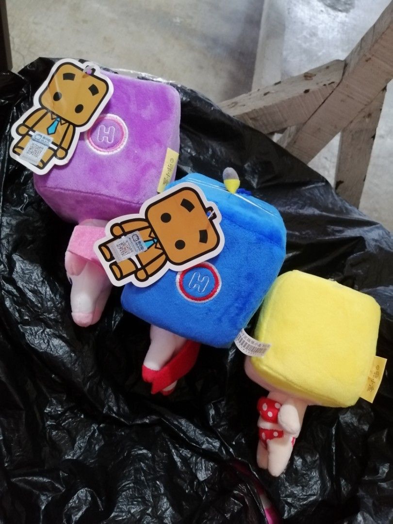 Mr. Box Cube Character Plush Toys Set of 3 (Category: Plushies & Soft Toys) located in Angono. Submitted by rlinee_93 (Listing ID 1467984607, Image 2). Description: - Set of 3 Mr. Box plush toys (Yellow, Blue, Purple) - Distinct square cube heads with unique character expressions and attached tags - Yellow plush wears heart sunglasses and a red polka dot bikini - Blue and purple plushies dressed in detailed space suits with capes - Made with ultr