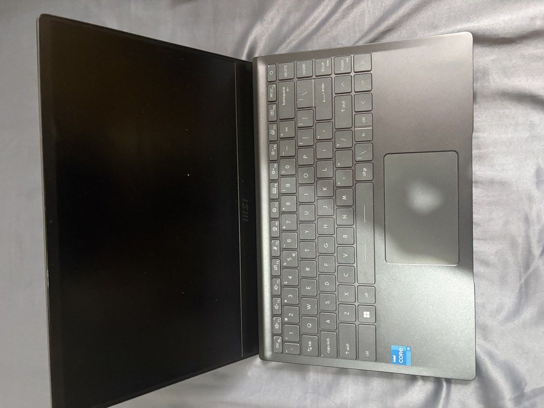 MSI Modern 14 14-inch Laptop Intel Core i3 (Category: Laptops & Notebooks) located in Imus. Submitted by migueldcs (Listing ID 1467866029, Image 2). Description: - Brand/Model: MSI Modern 14 (Model MS-14D3) - Color: Sleek Dark Grey - Processor: Intel Core i3 - Manufacture Date: February 2022 - Keyboard: Standard QWERTY layout with a spacious trackpad - Camera: Built-in top bezel webcam - Cooling & Support: Multiple cooling vents and intact rubber