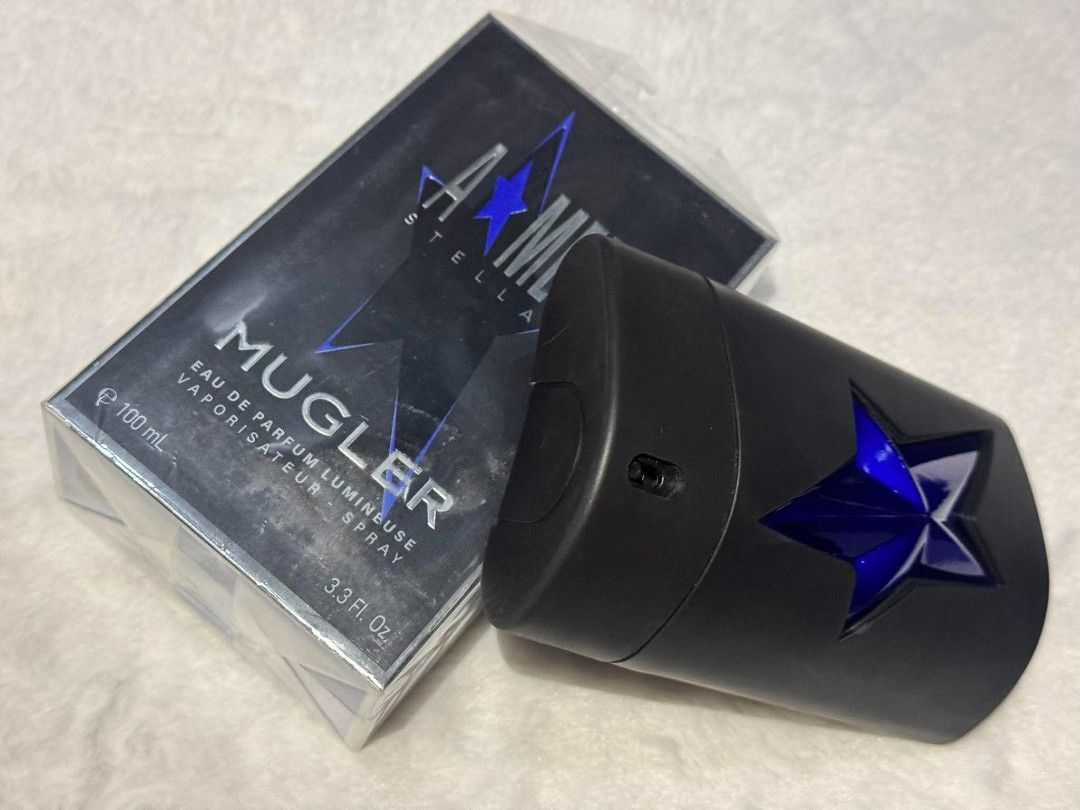 Mugler A*Men Stellar Eau de Parfum Lumineuse 100ml (Category: Fragrance & Deodorants) located in Quezon City. Submitted by trade_mnl (Listing ID 1468058187, Image 1). Description: - Brand: Mugler - Product: A*Men Stellar Eau de Parfum Lumineuse - Size: 100ml / 3.3 Fl. Oz. - Scent Profile: Rich amber woody fragrance - Bottle Design: Matte black spray bottle with a striking blue star - Condition: Good as new, opened box in original plastic packagin