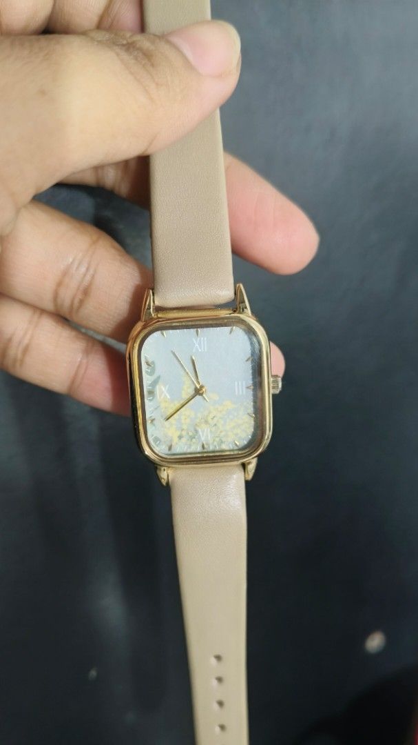 Nattito ASS159 Square Quartz Analog Watch (Category: Women's Watches) located in Taguig. Submitted by mercyeugen28914 (Listing ID 1467887059, Image 3). Description: - Brand: Nattito Women's Watch (Model: ASS159) - Design: Gold-tone square case with a classy beige leather strap - Dial: Stunning blue dial featuring a floral motif and Roman numerals (12, 3, 6, 9) - Movement: Japanese movement with stainless steel back construction - Condition: Brand