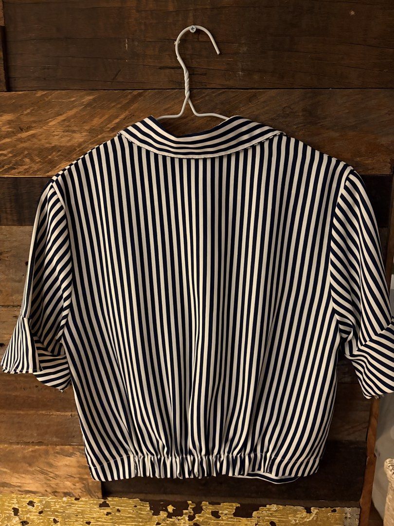 Navy and White Striped Button-Down Blouse with Twist Front (Category: Blouses) located in Quezon City. Submitted by makingroomfinds (Listing ID 1467983455, Image 2). Description: - Navy and white striped short-sleeve shirt with a folded collar - Button-up front, cute twist-knot hem, and back horizontal stripes with an elastic waistband - Lightweight, comfortable, and breathable fabric.