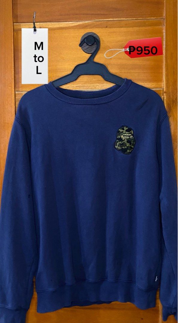 Navy Blue Camo Ape Patch Sweatshirt Size M to L (Category: Coats, Jackets and Outerwear) located in Baguio. Submitted by heath2600 (Listing ID 1468011652, Image 1). Description: - Color: Dark blue - Design: Embroidered camo ape patch on upper chest - Fit: Comfortable fit for medium to large frames - Material: Heavy cotton fabric, warm and soft - Features: Ribbed collar, cuffs, and hem to maintain shape - Style: Great everyday basic pullover for c