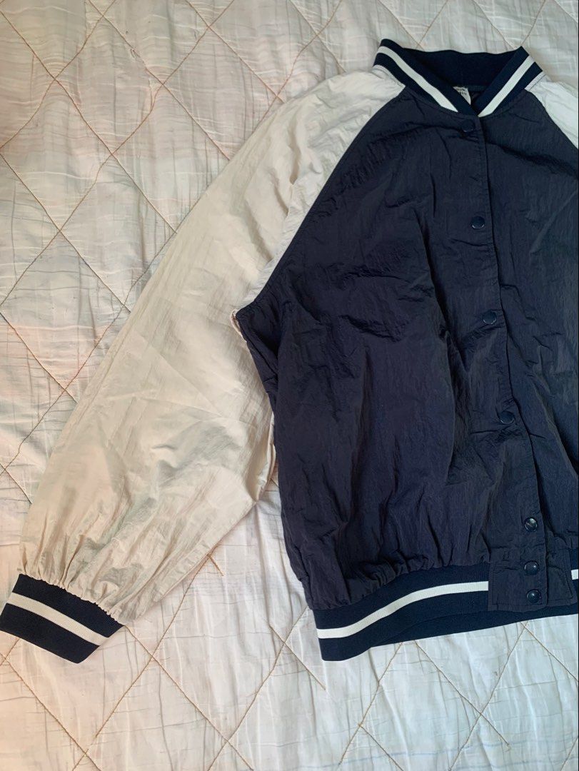 Navy Blue Oversized Bomber Jacket (Category: Coats, Jackets and Outerwear) located in Bacoor. Submitted by krisery (Listing ID 1467940437, Image 3). Description: - Brand: Vnook Studio - Style: Colorblock bomber jacket (Navy blue and Cream) - Size: Large on tag - Chest: 26 inch - Length: 25.5 inch - Arm Length starting from Underarm: 18 inch - Closure: Snap button front - Details: White raglan sleeves, ribbed collar, cuffs, and hem with white stri