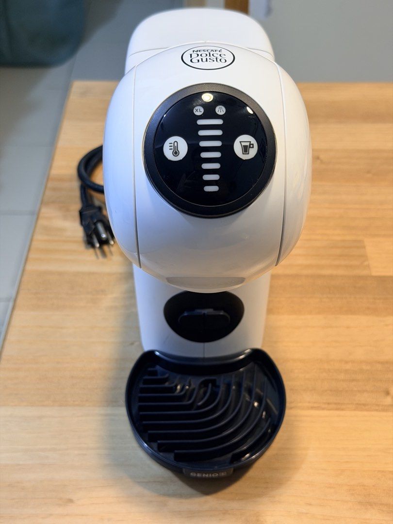 NESCAFÉ Dolce Gusto Genio S (Category: Coffee Machines & Makers) located in Pasig City. Submitted by myprelovedcorner (Listing ID 1467897023, Image 1). Description: Preloved Nescafé Dolce Gusto Genio S * Max Pressure: 15 bar high-pressure pump extraction * Water Tank Capacity: 0.8 liters (removable) * Capsule Bin Capacity: Holds up to 6 used capsules * Voltage: 220V * Dimensions (Genio S Basic): Width: 11.21 cm, Height: 27.32 cm, Depth: 28.65 cm 