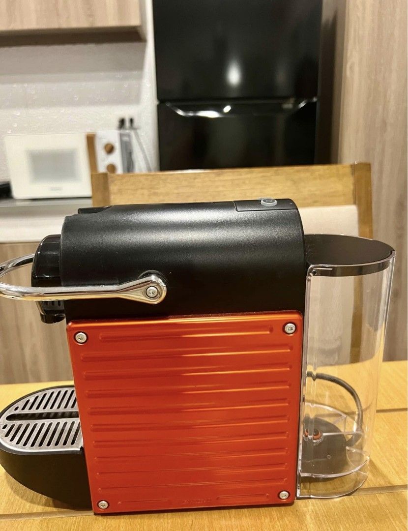 🛍Nespresso Pixie Espresso Machine Red and Black (Category: Coffee Machines & Makers) located in Makati City. Submitted by thehoardersgaragemnl (Listing ID 1467842632, Image 2). Description: - Model: Compact Nespresso Pixie espresso machine - Color: Striking red and black with stylish metal side panels - Compatibility: Works with standard Nespresso capsules - Performance: Quick heat-up system for fast daily brewing - Features: Clear rear water ta