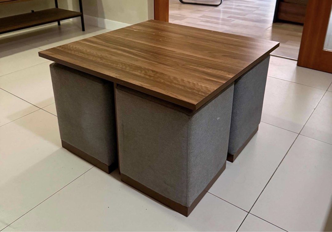 Nested Coffee Table with 3 Ottoman Stools (Category: Tables & Sets) located in Cebu City. Submitted by kirahangeline (Listing ID 1467879825, Image 2). Description: - Space-saving design: 3 grey fabric stools tuck neatly under the table - Stylish finish: Wood grain top with sturdy dark bases - Practical: Easy to pull out for users.