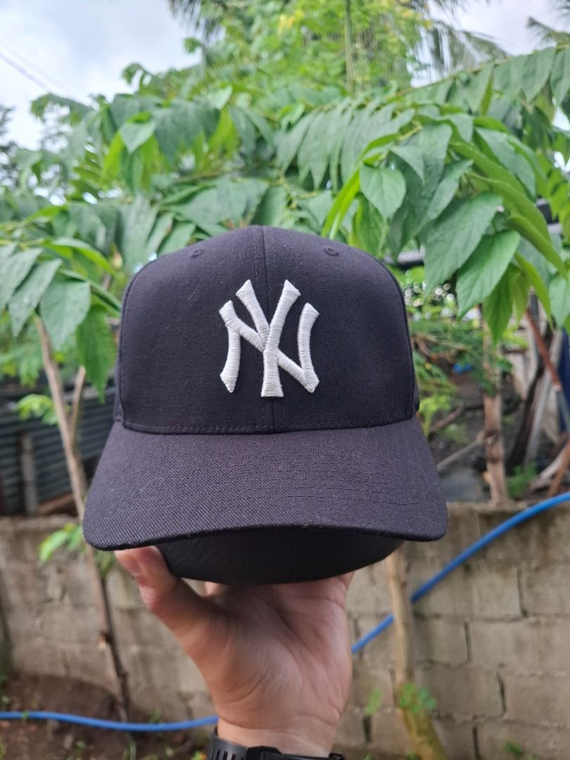New York Yankees MLB Black Cap (Category: Caps & Hats) located in Caloocan City. Submitted by bobmarlou1923 (Listing ID 1467842783, Image 3). Description: - Color: Classic Black - Design: White embroidered New York Yankees NY logo on the front - Fit: Adjustable strap with metal clasp in the back - Brim: Classic curved brim - Details: Official Major League Baseball seam taping and brand tags attached - Condition: Brand new, clean, and ready to wea