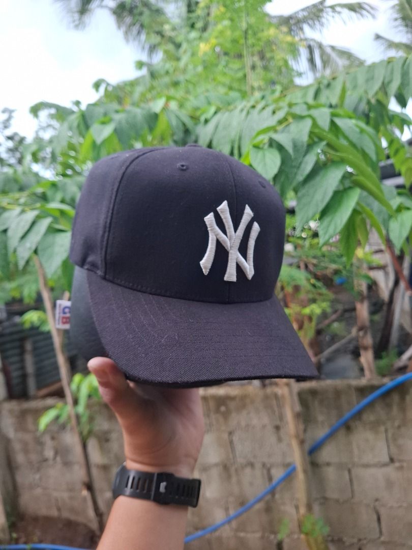 New York Yankees MLB Black Cap (Category: Caps & Hats) located in Caloocan City. Submitted by bobmarlou1923 (Listing ID 1467842783, Image 2). Description: - Color: Classic Black - Design: White embroidered New York Yankees NY logo on the front - Fit: Adjustable strap with metal clasp in the back - Brim: Classic curved brim - Details: Official Major League Baseball seam taping and brand tags attached - Condition: Brand new, clean, and ready to wea
