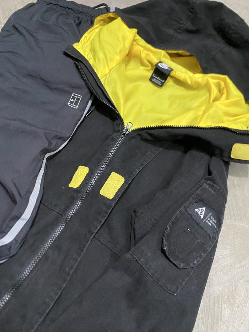 Nike ACG Jacket Trackpats ACG Yellow Set (Category: Coats, Jackets and Outerwear) located in Las Pinas. Submitted by 2fly.margiela (Listing ID 1467870926, Image 3). Description: - Brand: Nike ACG - Color: Black jacket with bright yellow lining & dark grey track pants - Details: Yellow swoosh logo, sleeve ACG patch, side stripes, and zippered pockets - Style: Streetwear / Outdoor activewear - Condition: Excellent / Ready to wear.