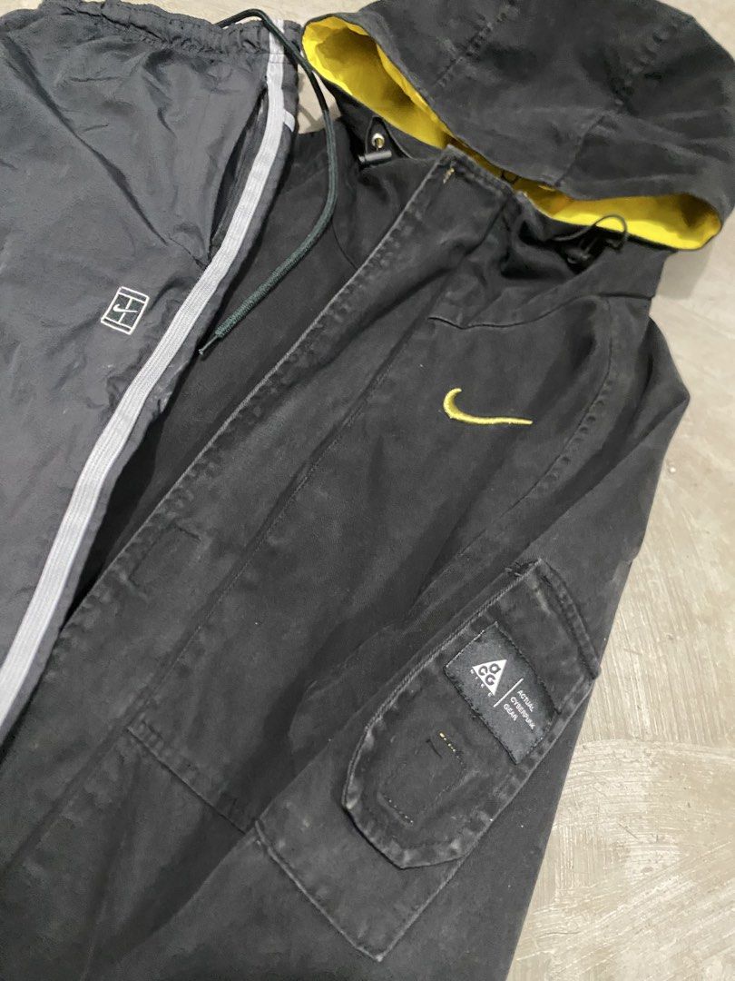 Nike ACG Jacket Trackpats ACG Yellow Set (Category: Coats, Jackets and Outerwear) located in Las Pinas. Submitted by 2fly.margiela (Listing ID 1467870926, Image 2). Description: - Brand: Nike ACG - Color: Black jacket with bright yellow lining & dark grey track pants - Details: Yellow swoosh logo, sleeve ACG patch, side stripes, and zippered pockets - Style: Streetwear / Outdoor activewear - Condition: Excellent / Ready to wear.