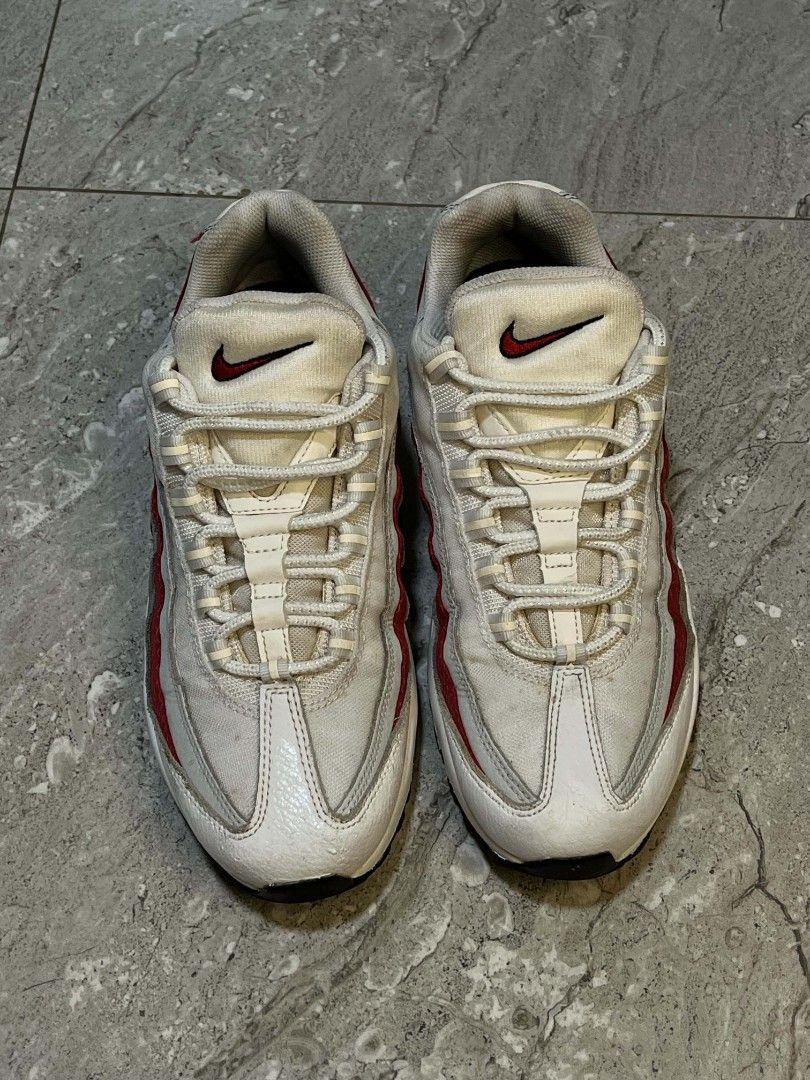Nike Air Max 95 White Red Grey (Category: Sneakers) located in Manila. Submitted by stephen_thrift (Listing ID 1467949788, Image 2). Description: - Brand: Nike - Model: Air Max 95 - Colorway: White, Grey, and Red - Design: Iconic layered upper with red branding on the tongue and side heel - Soles: Visible air units in the midsole - Closure: Standard lace-up with rope laces - Condition: Clean overall appearance with minimal signs of wear.