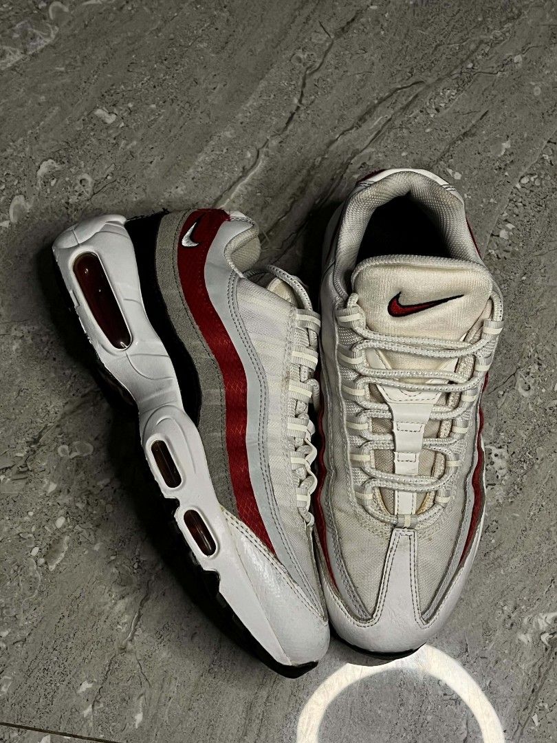 Nike Air Max 95 White Red Grey (Category: Sneakers) located in Manila. Submitted by stephen_thrift (Listing ID 1467949788, Image 3). Description: - Brand: Nike - Model: Air Max 95 - Colorway: White, Grey, and Red - Design: Iconic layered upper with red branding on the tongue and side heel - Soles: Visible air units in the midsole - Closure: Standard lace-up with rope laces - Condition: Clean overall appearance with minimal signs of wear.