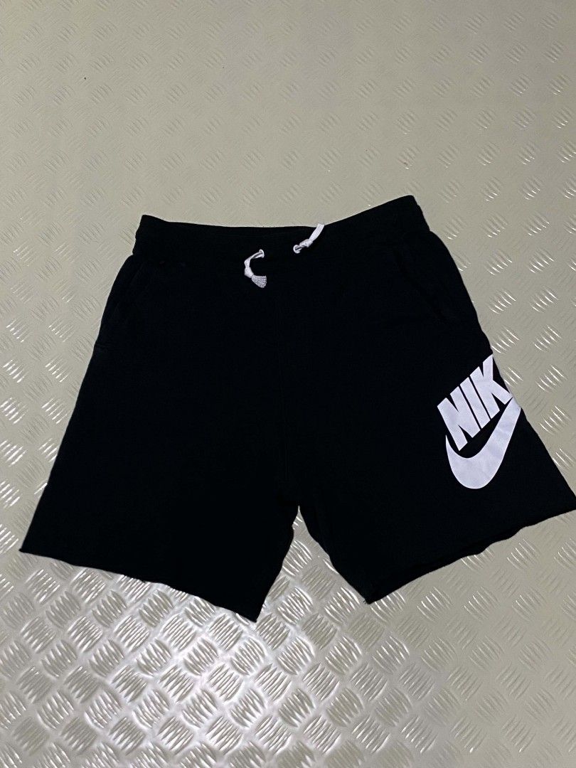 Nike Alumni XL (Category: Shorts) located in Dipolog. Submitted by just_thriftfinds (Listing ID 1467847304, Image 2). Description: - Brand: Nike - Item: Fleece Shorts - Size: XL - Color: Black with large white logo on left leg - Material: Cotton and polyester blend (Made in Thailand) - Features: Elastic waistband with adjustable white drawstring, side pockets, single back pocket - Condition: Excellent / Pre-loved - Best for: Lounging, gym workout