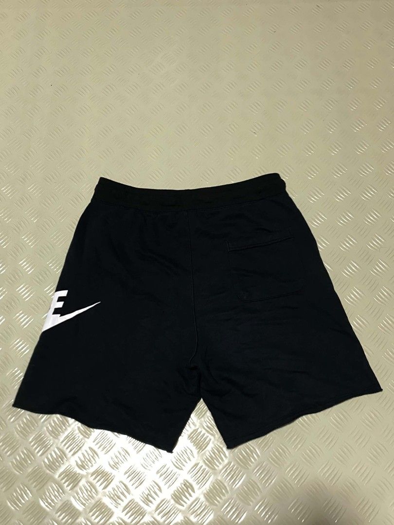 Nike Alumni XL (Category: Shorts) located in Dipolog. Submitted by just_thriftfinds (Listing ID 1467847304, Image 3). Description: - Brand: Nike - Item: Fleece Shorts - Size: XL - Color: Black with large white logo on left leg - Material: Cotton and polyester blend (Made in Thailand) - Features: Elastic waistband with adjustable white drawstring, side pockets, single back pocket - Condition: Excellent / Pre-loved - Best for: Lounging, gym workout