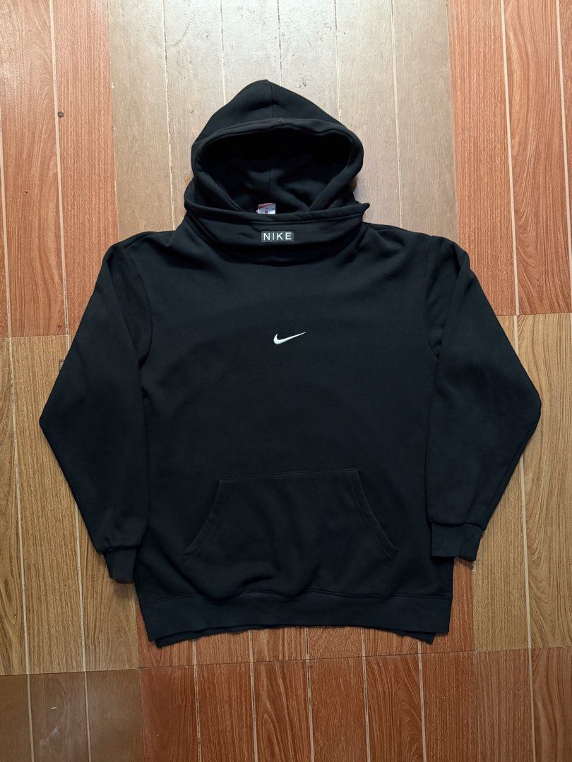 Nike Black Hoodie with Double Collar Design (Category: Coats, Jackets and Outerwear) located in Dasmarinas. Submitted by kylebecker (Listing ID 1467943965, Image 1). Description: - Color: Black with embroidered white swoosh - Style: Pullover hoodie with unique layered mock neck - Detail: Authentic rectangular Nike box logo tag on the collar - Features: Standard front kangaroo pocket, ribbed cuffs, and hem - Condition: Clean shape with minimal fad