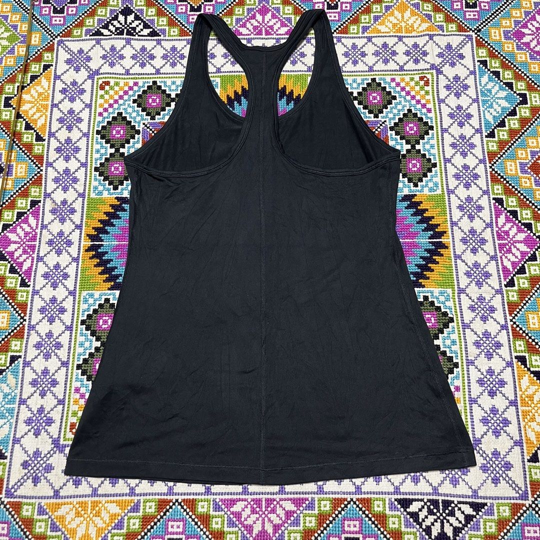 Nike Black Racerback Athletic Tank Top (Category: Activewear) located in Dagupan City. Submitted by vernzkee (Listing ID 1467867182, Image 3). Description: - Brand: Nike - Item: Athletic Tank Top - Color: Black - Design: Racerback with reflective swoosh logo near bottom hem - Material: Soft, stretch fabric ideal for running, gym, or casual wear - Dimensions: 15.5" pit-to-pit, 25.5" length - Condition: Excellent, clean with no stains or holes Loca
