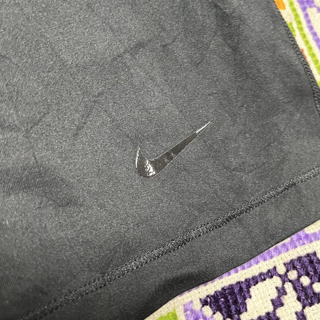 Nike Black Racerback Athletic Tank Top (Category: Activewear) located in Dagupan City. Submitted by vernzkee (Listing ID 1467867182, Image 2). Description: - Brand: Nike - Item: Athletic Tank Top - Color: Black - Design: Racerback with reflective swoosh logo near bottom hem - Material: Soft, stretch fabric ideal for running, gym, or casual wear - Dimensions: 15.5" pit-to-pit, 25.5" length - Condition: Excellent, clean with no stains or holes Loca