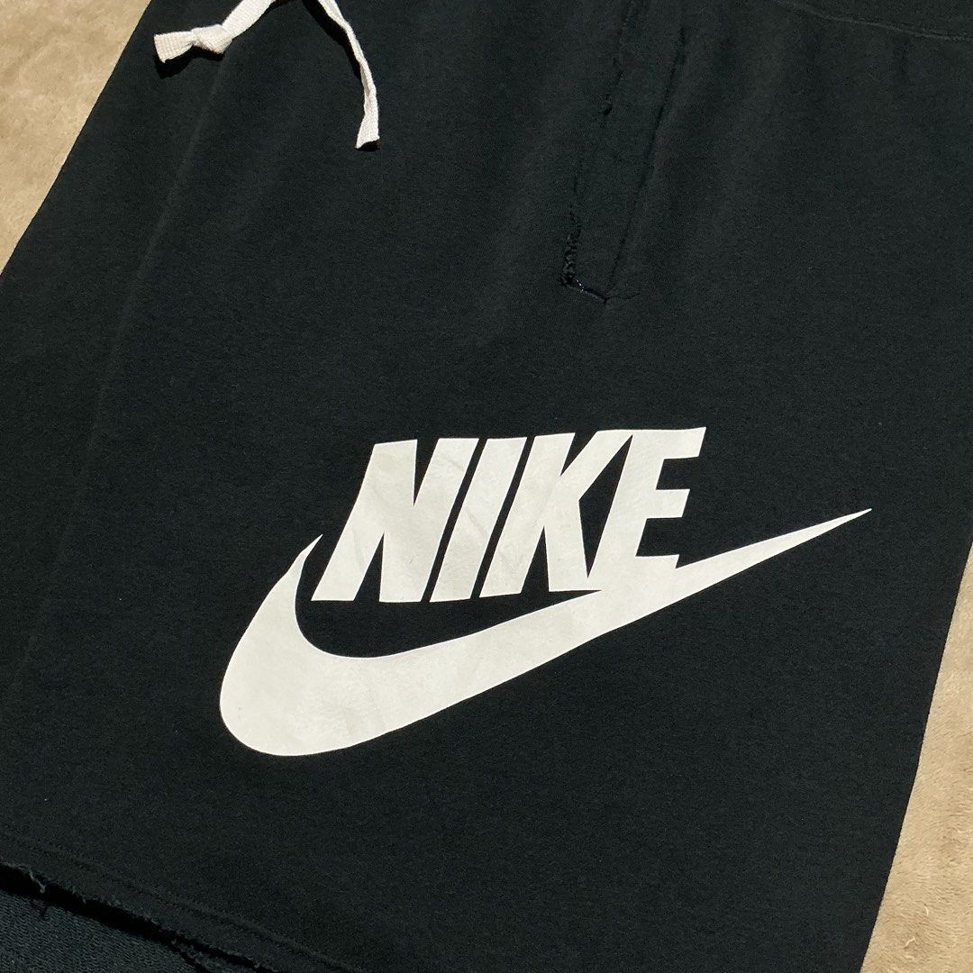 Nike Black Shorts with White Logo Size M (Category: Shorts) located in Naga. Submitted by lootersfinder (Listing ID 1467974720, Image 3). Description: - Brand: Nike - Style Code: AR2376-010 - Size: Medium (M) - Color: Black with large white swoosh logo - Material: 58% Cotton, 23% Rayon (cotton blend) - Features: Elastic waistband with white drawstring cords, convenient side pockets - Condition: Brand new with tags.