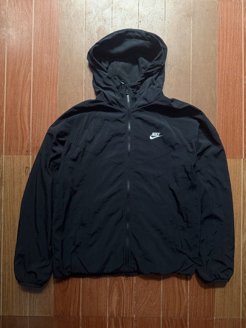 Nike Black Windbreaker Jacket with Hood (Category: Coats, Jackets and Outerwear) located in Dasmarinas. Submitted by kylebecker (Listing ID 1467943948, Image 1). Description: - Authentic Black Nike windbreaker jacket - Full zip front with attached, fleece-lined hood and drawstrings - Iconic white embroidered Nike swoosh on the chest - Convenient side zip pockets for your essentials - Lightweight material, perfect for breezy days or air-conditione