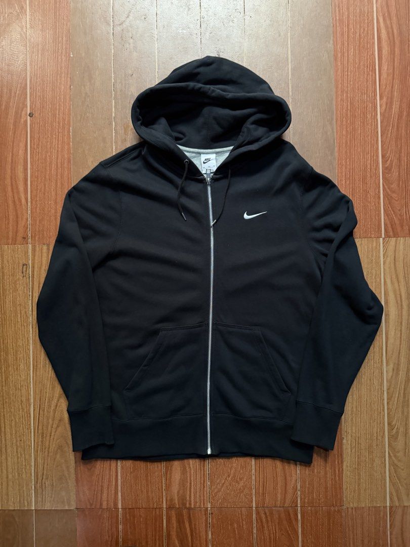 Nike Black Zip-Up Hoodie (Category: Hoodies) located in Dasmarinas. Submitted by kylebecker (Listing ID 1467943944, Image 1). Description: - Brand: Nike - Color: Black with white Swoosh logo on left chest - Style: Zip-up hoodie with adjustable drawstrings - Pockets: Two functional front pockets - Material: Soft and comfortable cotton blend - Fit/Details: Ribbed cuffs and hem for a snug fit - Condition: Great daily layer, grab it before it's gone!