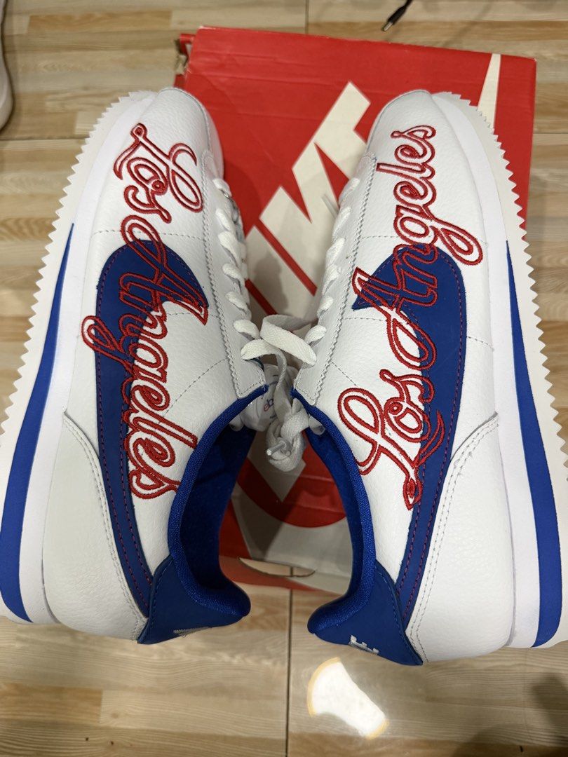 Nike Cortez Basic Leather Los Angeles Sneakers Size 10 (Category: Casual Shoes) located in Tabuk. Submitted by farawayluxe (Listing ID 1468046191, Image 2). Description: - Model: Nike Cortez - Colorway: White and Game Royal with red LA script embroidery - Size: US 10 / UK 9 / EUR 44 - Condition: Clean uppers and crisp white laces - Inclusions: Original red Nike box and eBay authenticity tag - Authenticity guaranteed.