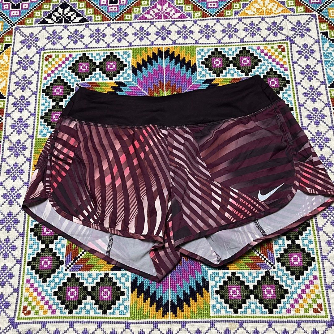 Nike Dri-FIT Printed Running Shorts (Category: Shorts) located in Dagupan City. Submitted by vernzkee (Listing ID 1467870090, Image 1). Description: - Brand: Nike - Type: Running / Workout Shorts - Size: Medium - Country of Manufacture: Malaysia - Design: Eye-catching purple geometric stripe pattern - Technology: Dri-FIT material to keep you dry and comfortable - Features: Wide black waistband with a secure back zippered pocket for essentials - C