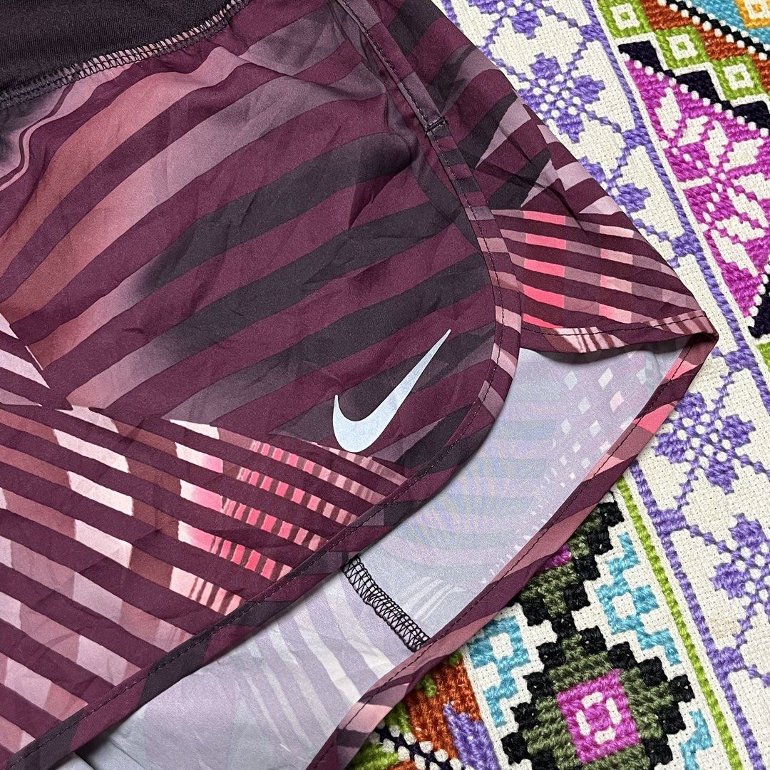 Nike Dri-FIT Printed Running Shorts (Category: Shorts) located in Dagupan City. Submitted by vernzkee (Listing ID 1467870090, Image 2). Description: - Brand: Nike - Type: Running / Workout Shorts - Size: Medium - Country of Manufacture: Malaysia - Design: Eye-catching purple geometric stripe pattern - Technology: Dri-FIT material to keep you dry and comfortable - Features: Wide black waistband with a secure back zippered pocket for essentials - C