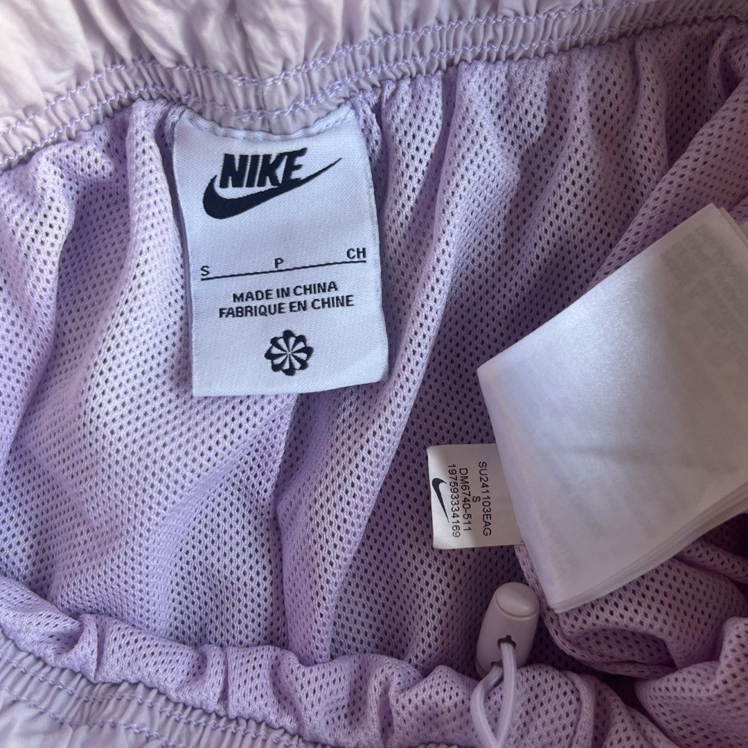 Nike Light Purple Shorts Size S (Category: Shorts) located in M'Lang. Submitted by alexpabillo0324 (Listing ID 1467924640, Image 3). Description: - Brand: Nike - Style/Color: Light Purple (Style Code: DM6740-511) - Size: Women's Small - Material: Lightweight crinkled nylon shell with breathable mesh lining - Fit & Features: Wide elastic waistband, adjustable drawcord, and two convenient side slip pockets - Design: Large printed Nike Swoosh graphi