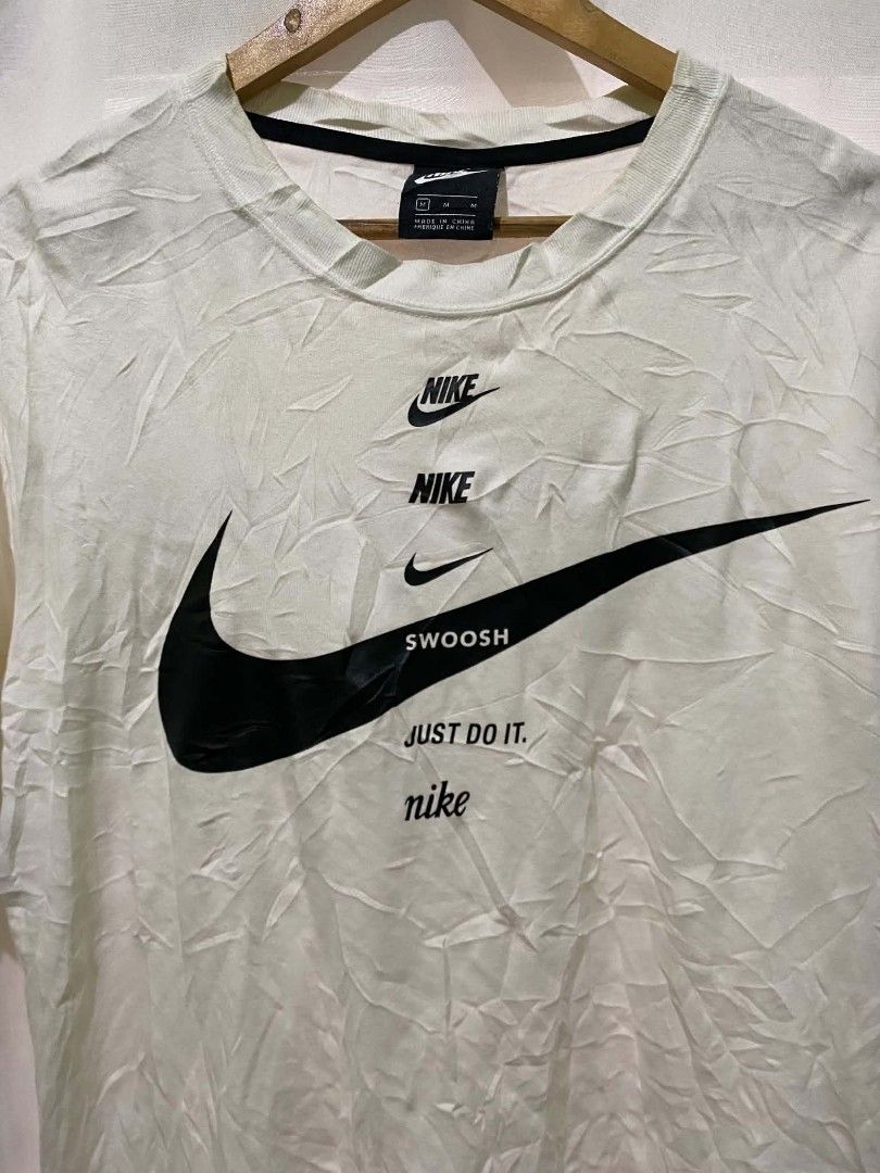Nike Multi Logo Swoosh Just Do It T-Shirt White (Category: Tshirts & Polo Shirts ) located in Quezon City. Submitted by elihur.tuazon (Listing ID 1467885708, Image 2). Description: - Brand: Nike - Style: Crewneck t-shirt with stacked chest logos, Swoosh graphics, and 'Just Do It' slogan - Color: White - Size: Medium - Fit: Standard fit - Details: CU5683-100 product code on inner tag, made in China - Condition: Excellent, ready to wear.