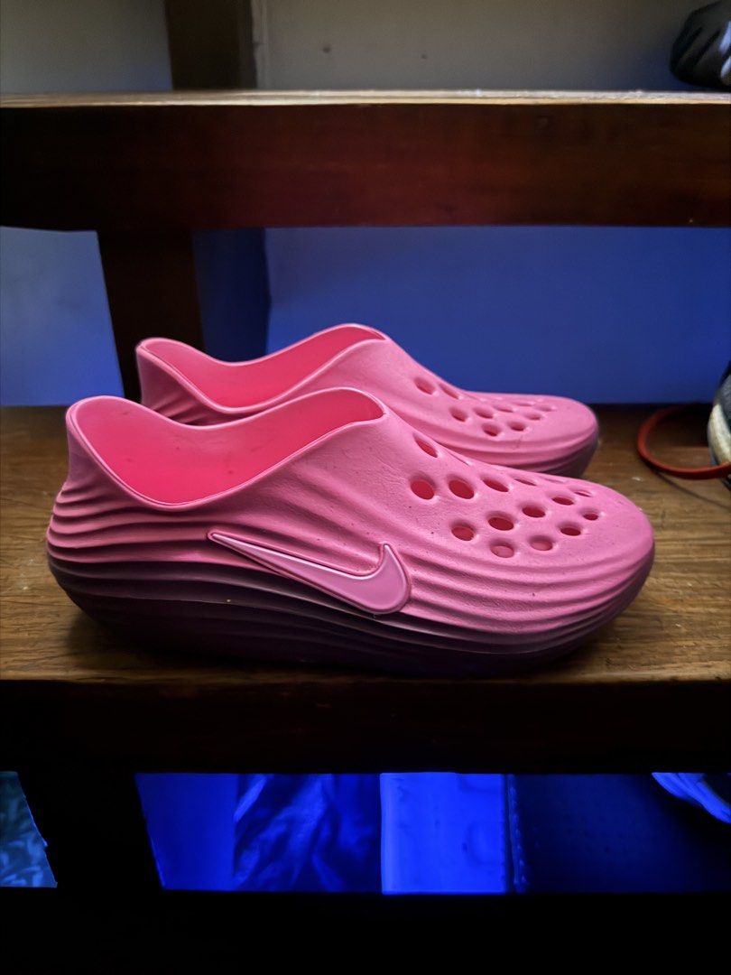 Nike Pink Clogs (Category: Slippers and slides) located in Manila. Submitted by quicktree_779876 (Listing ID 1467955875, Image 1). Description: - Color: Bright pink with a pink-to-purple gradient sole - Design: Slip-on clogs with ventilation holes and raised Nike swoosh logo - Material: Lightweight foam construction - Features: Easy to wash and quick to slip on - Condition: Brand new / Excellent quality.