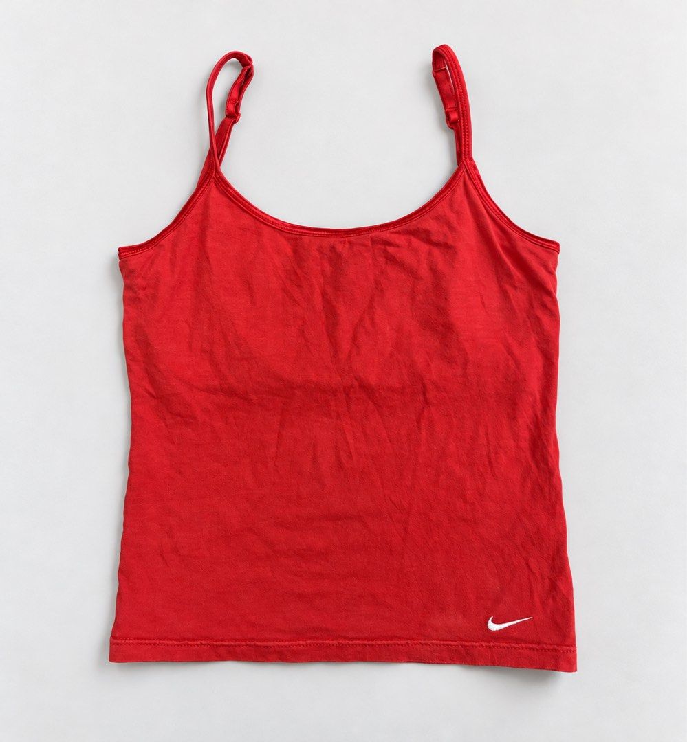 Nike Red Cami Tank Top with Adjustable Straps (Category: Sleeveless) located in Valencia. Submitted by bruuuuh (Listing ID 1468036205, Image 1). Description: - Color: Bright red - Brand: Nike - Material: Soft cotton blend with great stretch - Design: Classic scoop neck with thin adjustable straps - Detail: Small white embroidered Nike swoosh logo near the hem - Versatility: Ideal for workouts, layering, or casual everyday wear - Condition: Excell