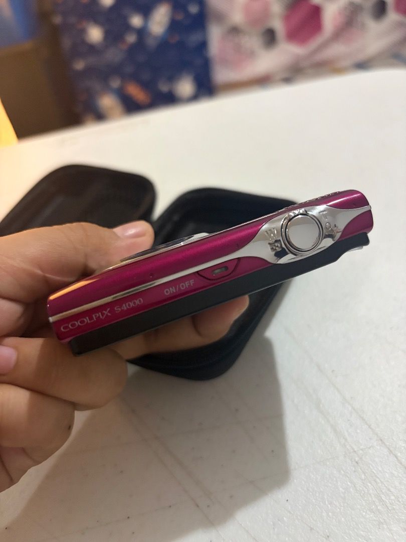 Nikon Coolpix S4000 (Category: Cameras) located in Bay. Submitted by zopiah_camera (Listing ID 1467981160, Image 2). Description: - Pink Nikon Coolpix S4000 digital camera, works great and perfect for Y2K aesthetic shots - Includes matching black hard case for protection and portability - Comes with original Nikon battery pack, power adapter, USB cable, and charging block - Includes a SanDisk 2GB SD card so you can start shooting immediately .