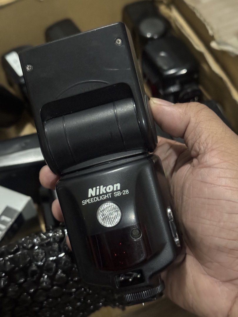 Nikon Speedlight SB-28 Flash (Category: Flashes) located in Tanay. Submitted by bentomendez (Listing ID 1467867655, Image 3). Description: - Nikon Speedlight SB-28 electronic flash unit in fully working condition - Powers up normally with a bright green illuminated LCD screen - Manual zoom and power controls for precise lighting - Standard hot shoe mount and side sync terminals - Battery door is intact and secure - Ready for use on compatible cam
