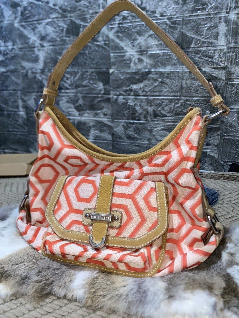 Nine West orange geometric pattern shoulder bag (Category: Shoulder Bags) located in San Jose. Submitted by dutgurl.jecha (Listing ID 1467852403, Image 1). Description: - Brand: Nine West - Design: Bold orange and white geometric pattern with tan leather-look trim - Details: Front flap pocket with silver hardware branding - Handle: Single top handle design - Structure: Fabric body with a sturdy base - Size: Handy everyday size, perfect for daily 